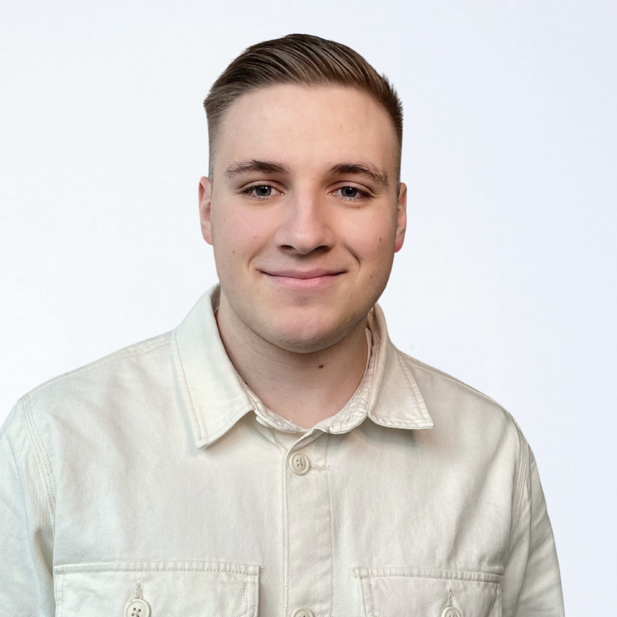 Portraitfoto von Florian Hermanns, er trägt ein helles Hemd, lächelt freundlich in die Kamera.