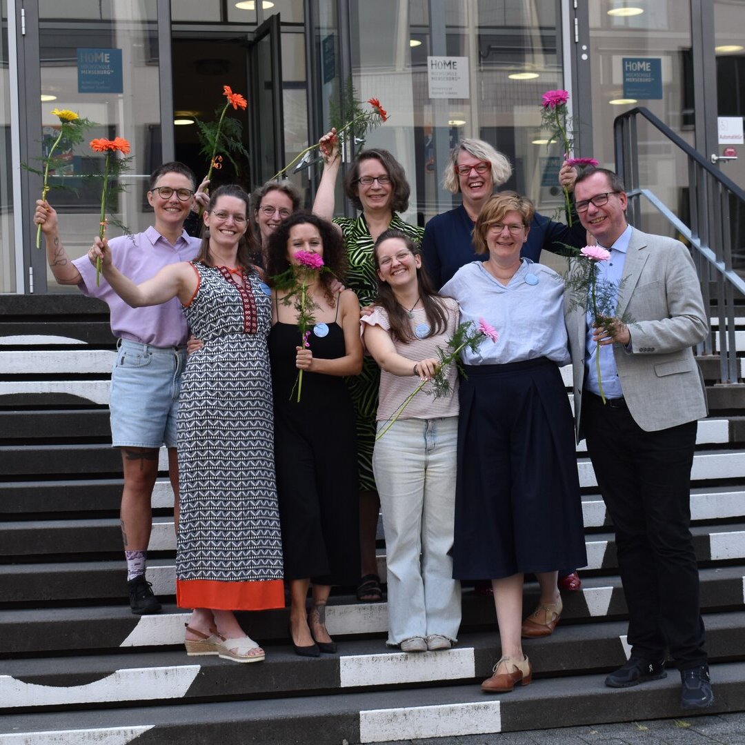Gruppenfoto der Absolvent*innen des Masterstudiengangs Sexologie. Rechts im Bild zu sehen ist der Studiengangsverantwortliche Prof. Dr. Heinz-Jürgen Voß s